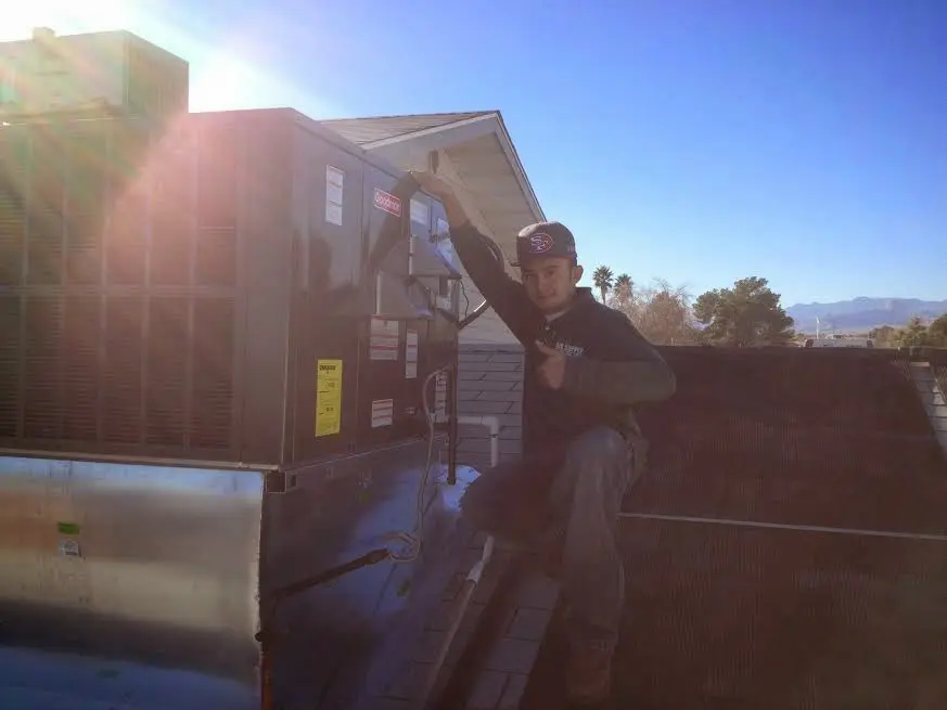HVAC technician performing HVAC Inspection on a rooftop unit in Whiskey Creek